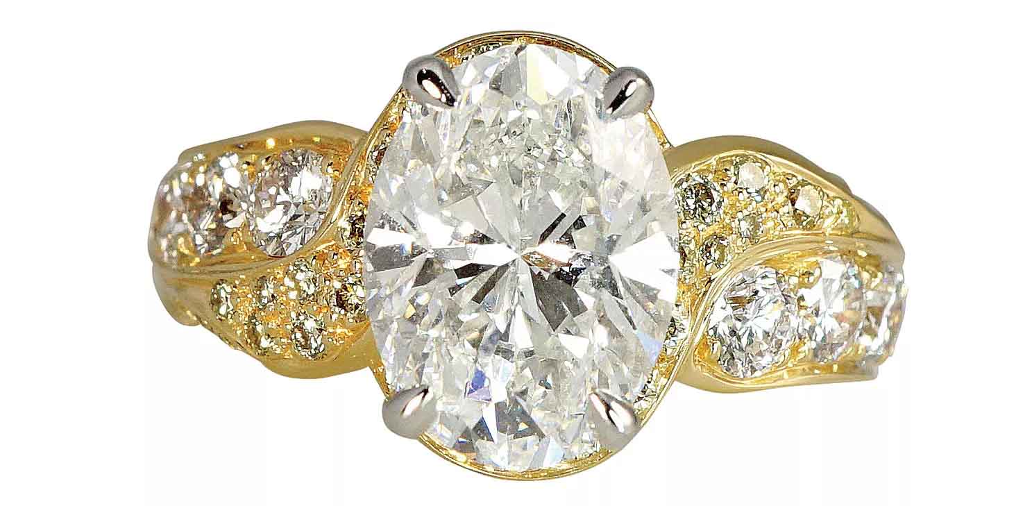 Jill custom engagement ring in 18k yellow gold and platinum with a 3.52 ct. oval center diamond