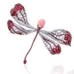 Dragonfly brooch in 18-karat white gold adorned with a conch pearl focal gem, rubies and diamonds
