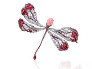 Dragonfly brooch in 18-karat white gold adorned with a conch pearl focal gem, rubies and diamonds