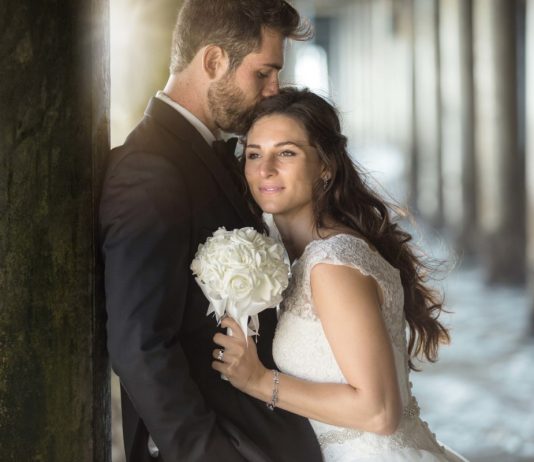 Average engagement ring spend is £1,650, study claims Two lovers embrace by the pier ocean with tuxedo and wedding dre