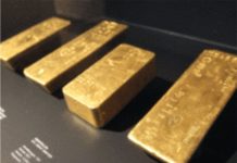 Gold prices subdued as dollar extends rally