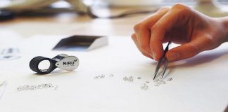 A worker inspects diamonds at Niru