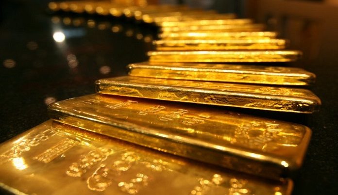 Gold eases from 1-week high as dollar nudges up