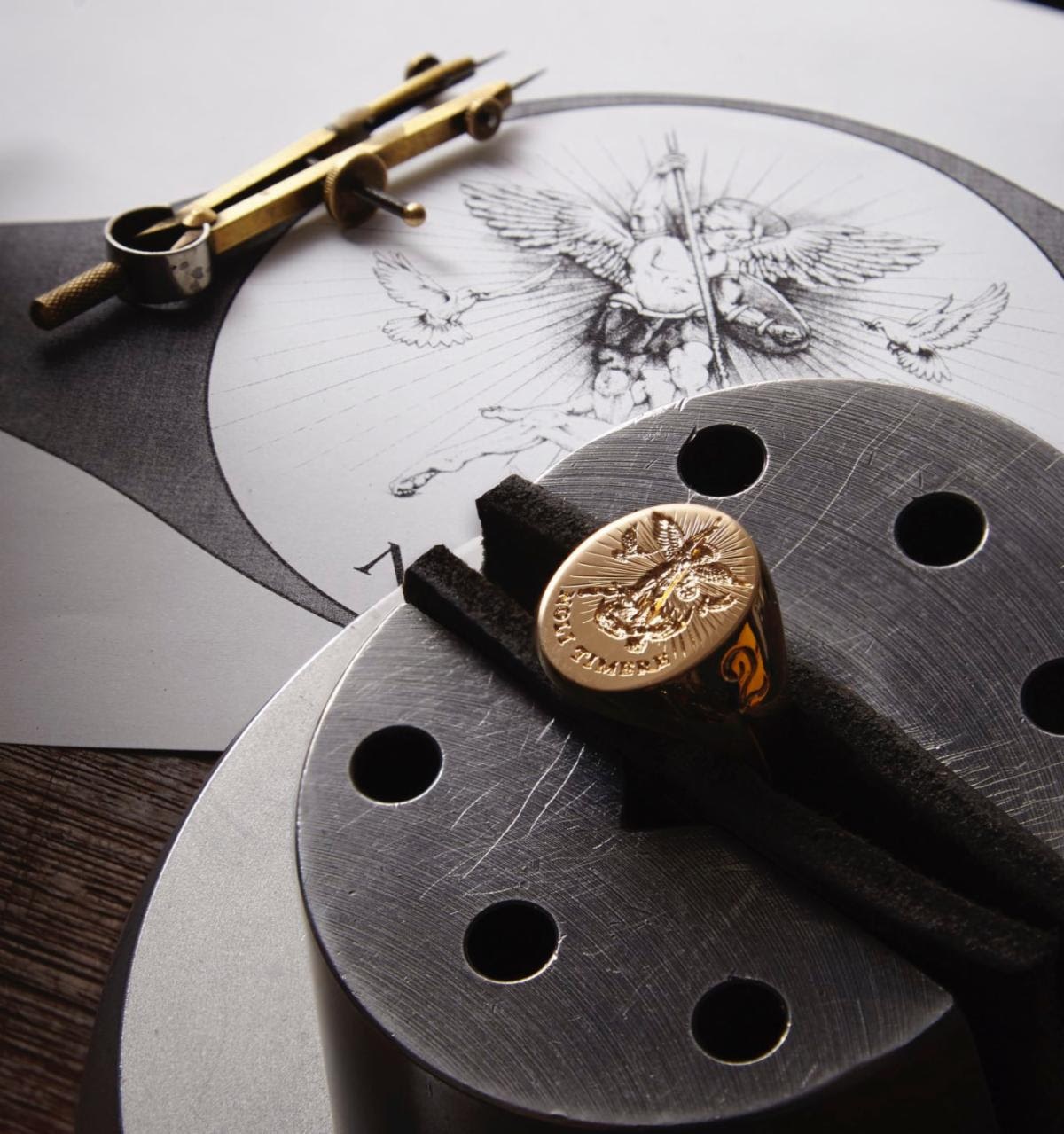 18K yellow gold signet ring by Rebus set in clamp alongside original sketch. Image courtesy of Rebus