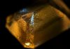 Orange Phosphorescence Hints at Lab Grown Defect